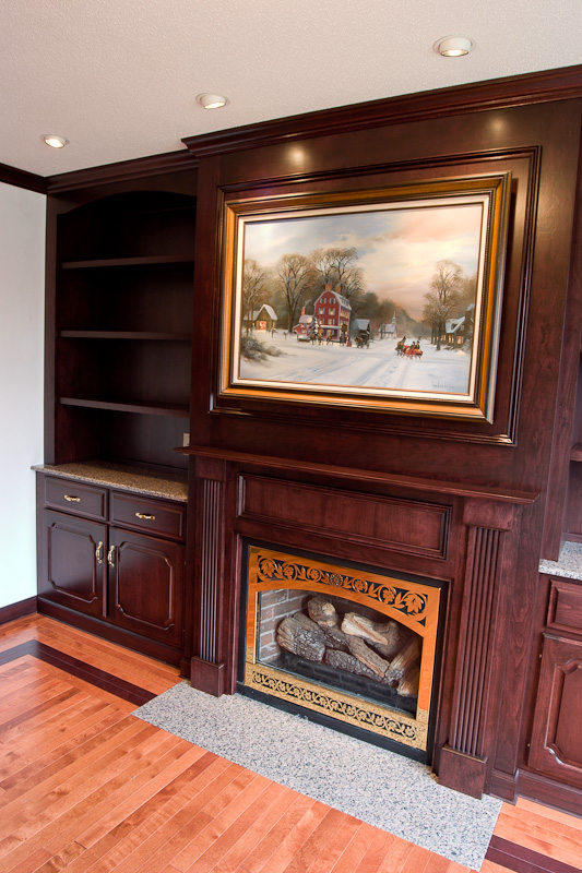 Custom cherry built-in cabinetry with a fireplace mantle and library cabinets. Glastonbury, CT