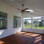 Interior of an enclosed porch in Ellington, CT. This 3 seaon porch has sliding windows, bead board ceiling, skylights and Ipe decking.